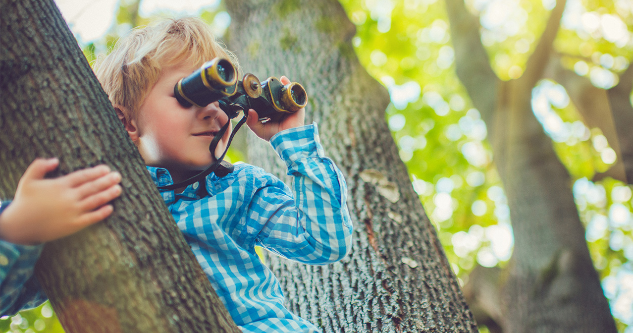 Kind sieht mit Fernglas in die Zukunft: Ganzheitliche Kindergesundheit